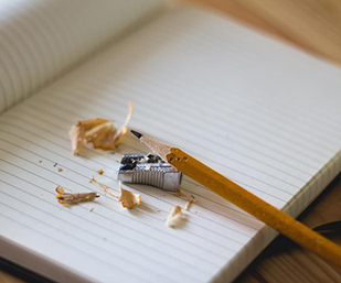Sharpened pencil on notebook